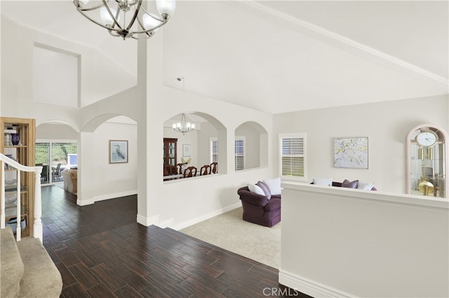 4 Westgate, Laguna Niguel, CA 92677 - unfurnished living room with a chandelier, high vaulted ceiling, baseboards, wood finish floors, and arched walkways