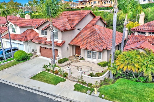 4 Westgate, Laguna Niguel, CA 92677 - mediterranean / spanish-style house with stucco siding, a tiled roof, an attached garage, concrete driveway, and a front yard