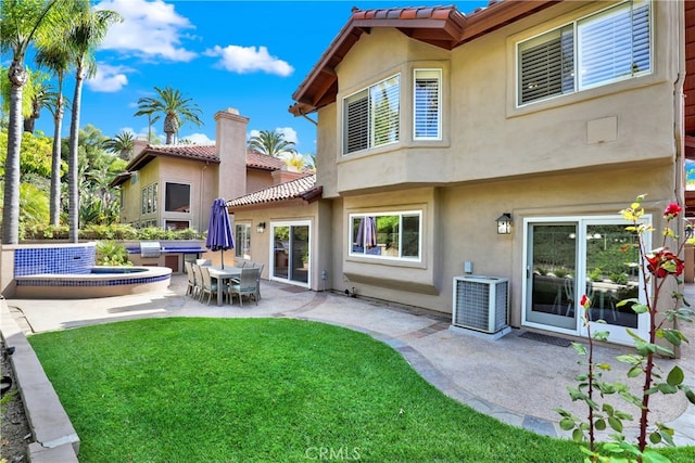 4 Westgate, Laguna Niguel, CA 92677 - rear view of property with cooling unit, a tiled roof, a lawn, and stucco siding