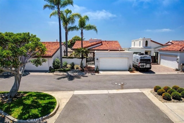 24155 Vis D Onde, Dana Point, CA 92629 - view of front facade featuring a tiled roof, stucco siding, solar panels, driveway, and an attached garage