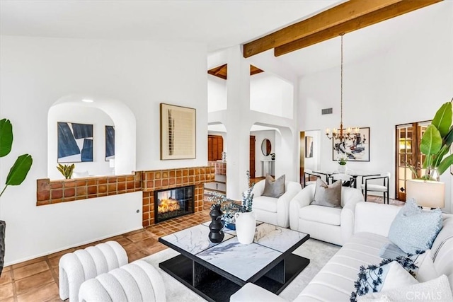 24155 Vis D Onde, Dana Point, CA 92629 - living room with a chandelier, a brick fireplace, beamed ceiling, high vaulted ceiling, and baseboards