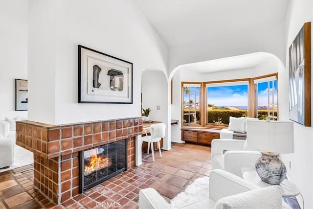 24155 Vis D Onde, Dana Point, CA 92629 - living room featuring arched walkways and a brick fireplace
