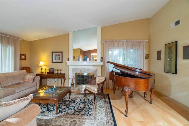 21357 Bermuda St, Chatsworth, CA 91311 - living area with plenty of natural light, wood finished floors, vaulted ceiling, a fireplace, and baseboards