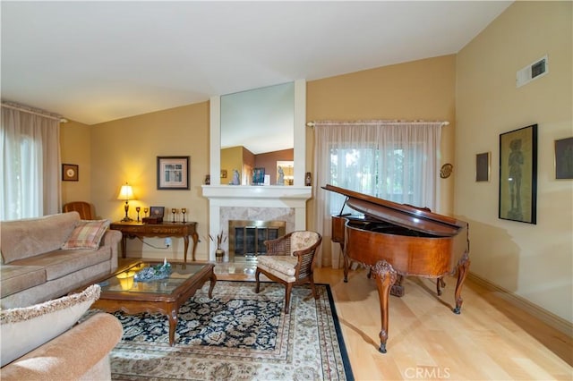 21357 Bermuda St, Chatsworth, CA 91311 - living area with vaulted ceiling, wood finished floors, a tile fireplace, and baseboards