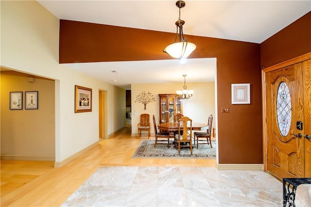 21357 Bermuda St, Chatsworth, CA 91311 - dining room with baseboards, a chandelier, light wood-style floors, and vaulted ceiling