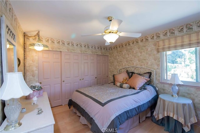 21357 Bermuda St, Chatsworth, CA 91311 - bedroom with light wood-style floors, a closet, wallpapered walls, and a ceiling fan