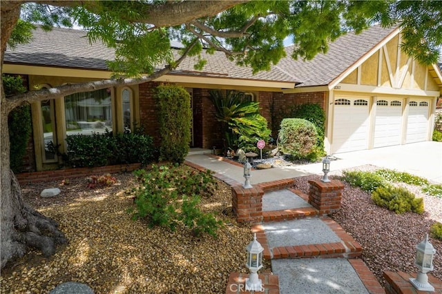 21357 Bermuda St, Chatsworth, CA 91311 - view of front facade featuring driveway, an attached garage, brick siding, and a shingled roof