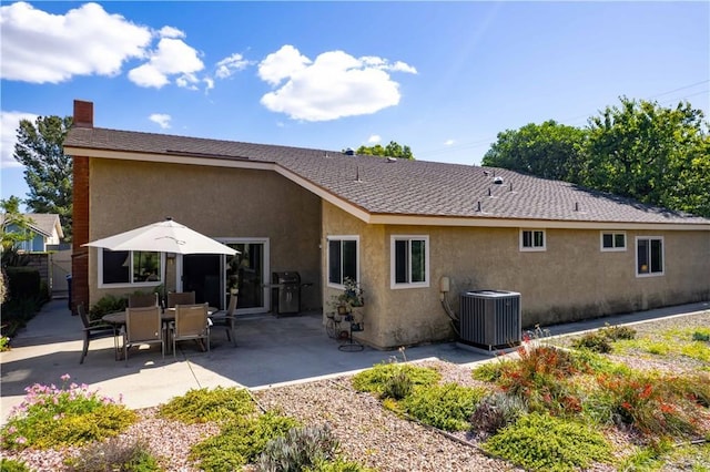 21357 Bermuda St, Chatsworth, CA 91311 - rear view of house featuring stucco siding, central AC, a patio area, and a chimney