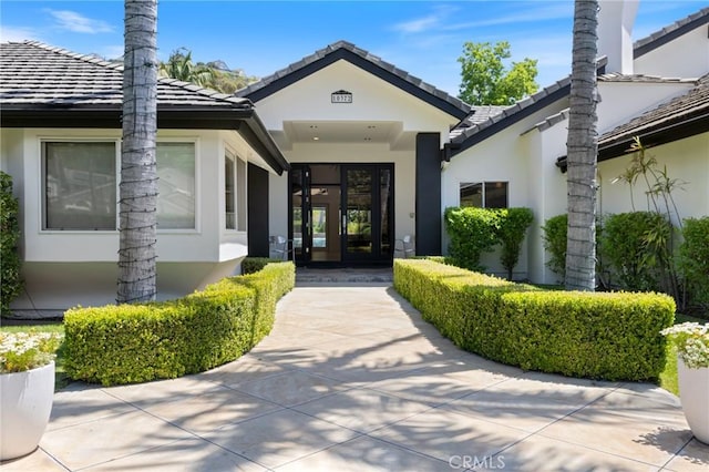 10372 Crawford Canyon Rd, North Tustin, CA 92705 - entrance to property featuring stucco siding, french doors, and a tile roof