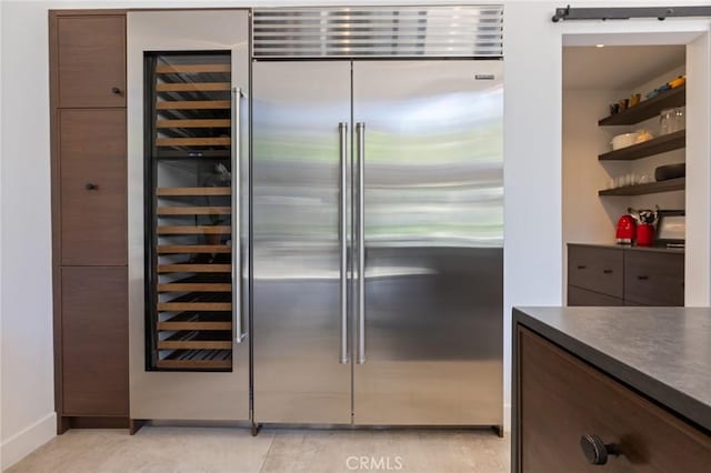 10372 Crawford Canyon Rd, North Tustin, CA 92705 - kitchen featuring dark countertops, stainless steel built in refrigerator, baseboards, modern cabinets, and dark brown cabinets
