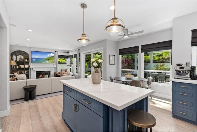 12 Argos, Laguna Niguel, CA 92677 - kitchen featuring light wood-style floors, a kitchen island, a ceiling fan, blue cabinetry, and recessed lighting