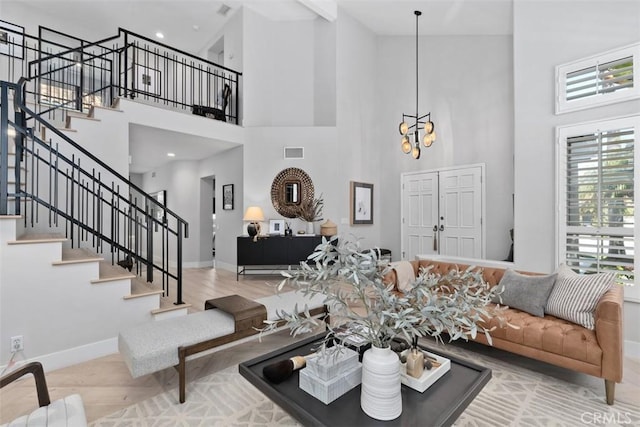 12 Argos, Laguna Niguel, CA 92677 - living area featuring a high ceiling, stairway, baseboards, wood finished floors, and a chandelier