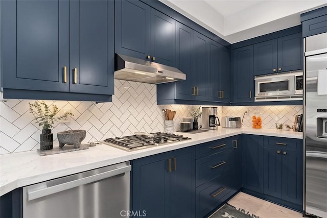 12 Argos, Laguna Niguel, CA 92677 - kitchen with built in appliances, blue cabinetry, and under cabinet range hood
