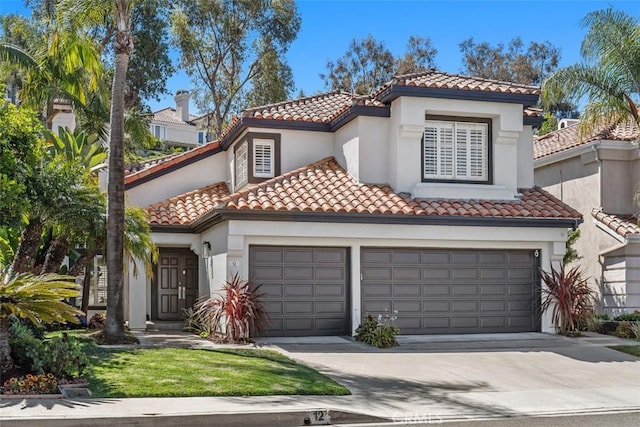 12 Argos, Laguna Niguel, CA 92677 - mediterranean / spanish-style home featuring a tile roof, driveway, stucco siding, and an attached garage