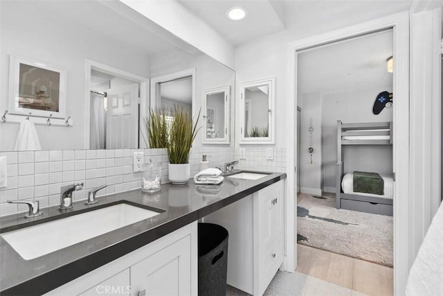 12 Argos, Laguna Niguel, CA 92677 - bathroom featuring tasteful backsplash, double vanity, curtained shower, wood finished floors, and recessed lighting