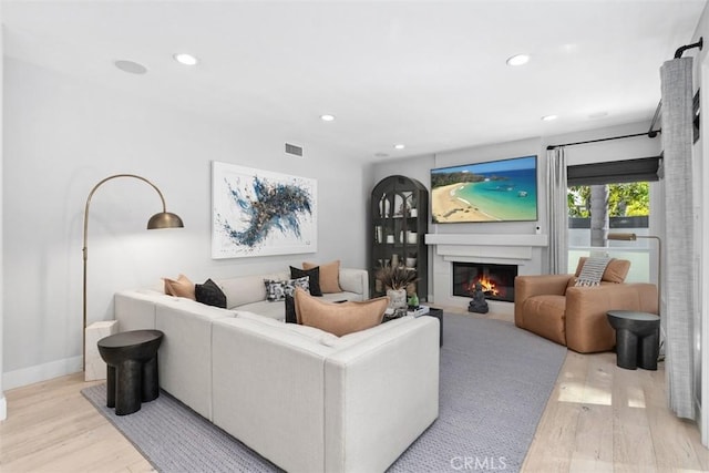 12 Argos, Laguna Niguel, CA 92677 - living area with light wood finished floors, a glass covered fireplace, recessed lighting, and baseboards
