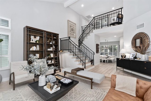 12 Argos, Laguna Niguel, CA 92677 - living room featuring stairway, high vaulted ceiling, beam ceiling, wood finished floors, and baseboards