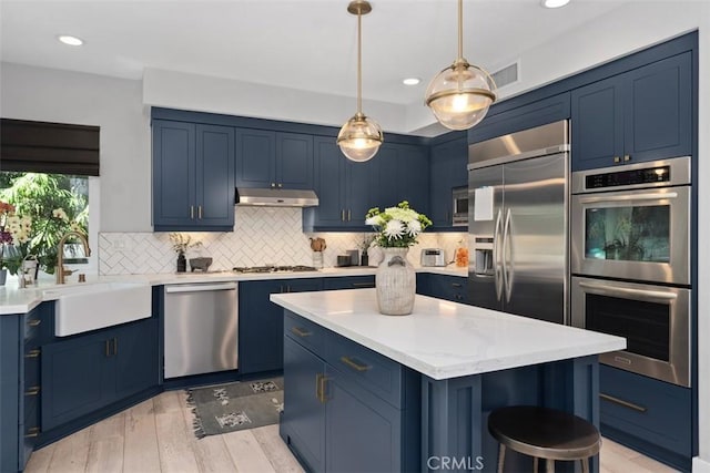 12 Argos, Laguna Niguel, CA 92677 - kitchen featuring blue cabinetry, stainless steel appliances, a sink, under cabinet range hood, and recessed lighting