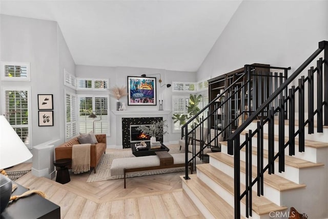 12 Argos, Laguna Niguel, CA 92677 - living area featuring high vaulted ceiling, a high end fireplace, stairs, and baseboards