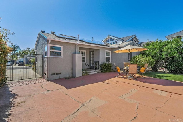 4719 Constance Dr, San Diego, CA 92115 - rear view of house featuring stucco siding, solar panels, a patio, and a gate
