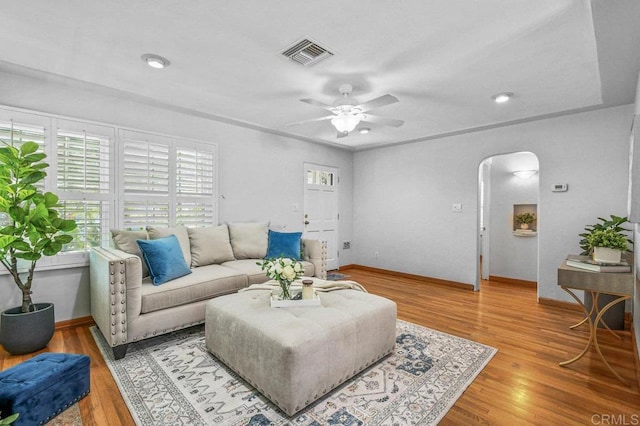 4719 Constance Dr, San Diego, CA 92115 - living room with arched walkways, ceiling fan, light wood-style floors, and baseboards