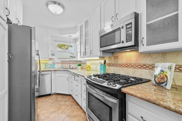 4719 Constance Dr, San Diego, CA 92115 - kitchen with stainless steel appliances, white cabinets, backsplash, and glass insert cabinets