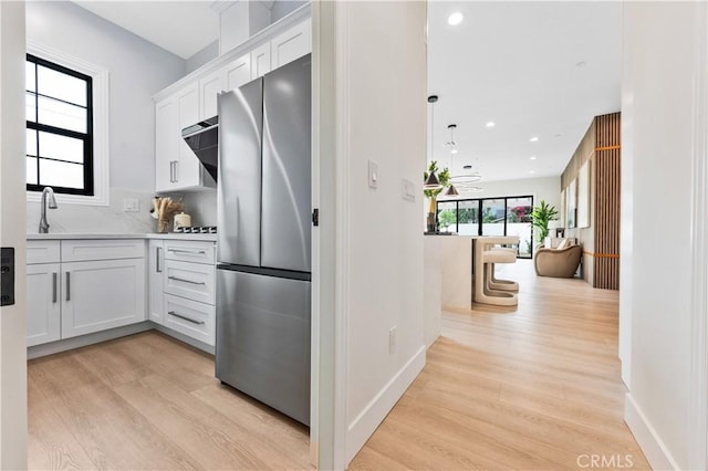 4947 Heleo Ave, Temple City, CA 91780 - kitchen featuring freestanding refrigerator, light wood-style flooring, white cabinets, a sink, and recessed lighting