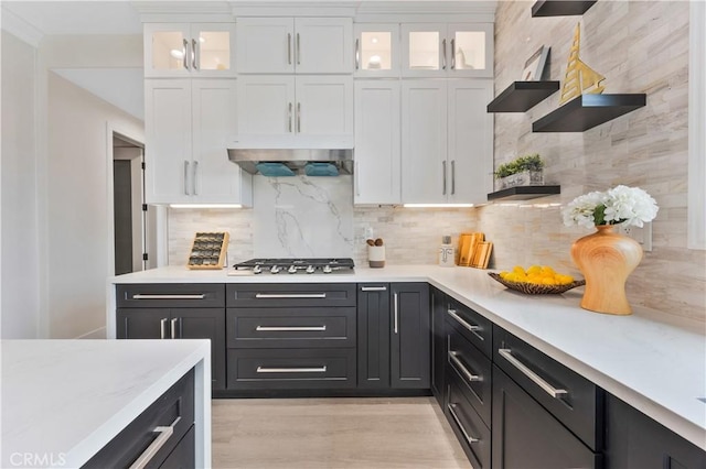 4947 Heleo Ave, Temple City, CA 91780 - kitchen featuring stainless steel gas cooktop, white cabinetry, tasteful backsplash, and glass insert cabinets