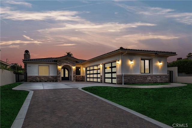 4947 Heleo Ave, Temple City, CA 91780 - view of front facade featuring stone siding, a garage, decorative driveway, a chimney, and stucco siding