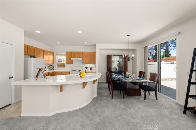 1634 Rigel St, Beaumont, CA 92223 - kitchen with white appliances, light carpet, a chandelier, healthy amount of natural light, and recessed lighting