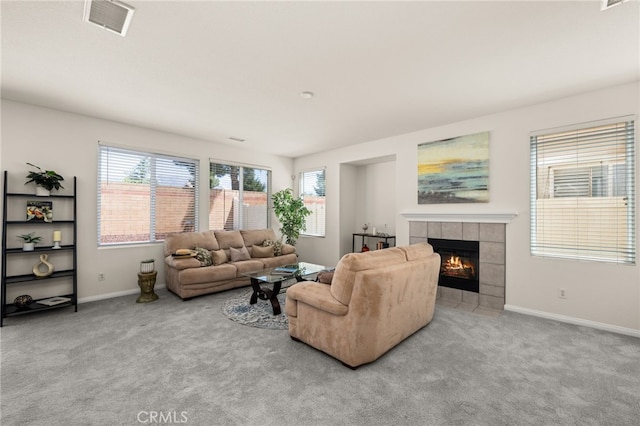 1634 Rigel St, Beaumont, CA 92223 - carpeted living area with plenty of natural light, baseboards, and a tile fireplace