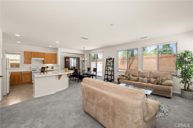 1634 Rigel St, Beaumont, CA 92223 - living room featuring light colored carpet, a chandelier, recessed lighting, and baseboards