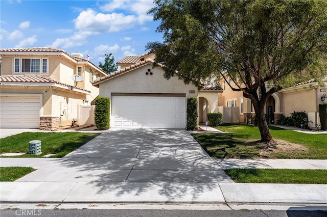 1634 Rigel St, Beaumont, CA 92223 - mediterranean / spanish home with stucco siding, driveway, stone siding, and a tiled roof