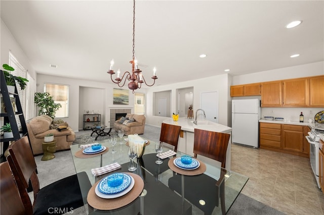 1634 Rigel St, Beaumont, CA 92223 - dining area with a chandelier, a fireplace, recessed lighting, and light tile patterned floors