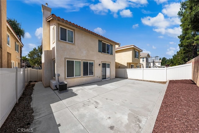 1634 Rigel St, Beaumont, CA 92223 - rear view of house featuring a tile roof, stucco siding, a fenced backyard, and a patio area