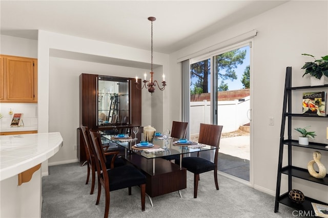 1634 Rigel St, Beaumont, CA 92223 - dining area featuring a chandelier, light carpet, and baseboards