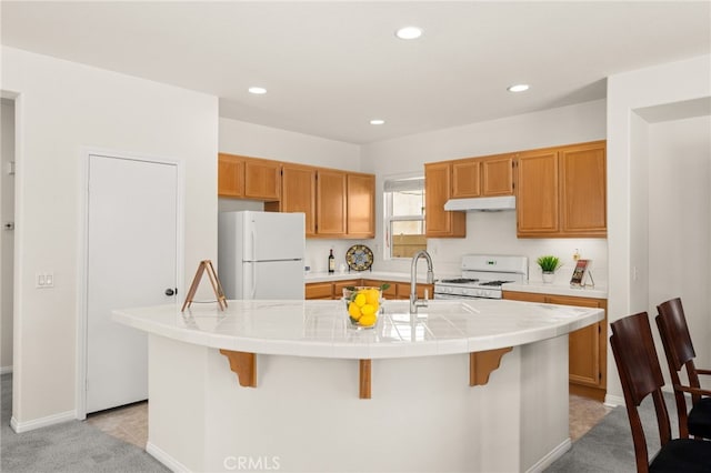 1634 Rigel St, Beaumont, CA 92223 - kitchen featuring white appliances, under cabinet range hood, a sink, tile counters, and recessed lighting