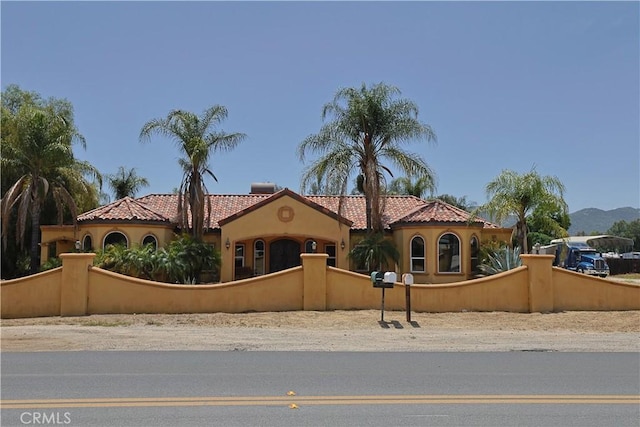 22331 Walnut St, Wildomar, CA 92595 - mediterranean / spanish-style house featuring a fenced front yard, stucco siding, and a tiled roof
