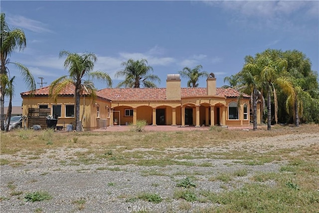 22331 Walnut St, Wildomar, CA 92595 - rear view of house with stucco siding, a tiled roof, and a chimney