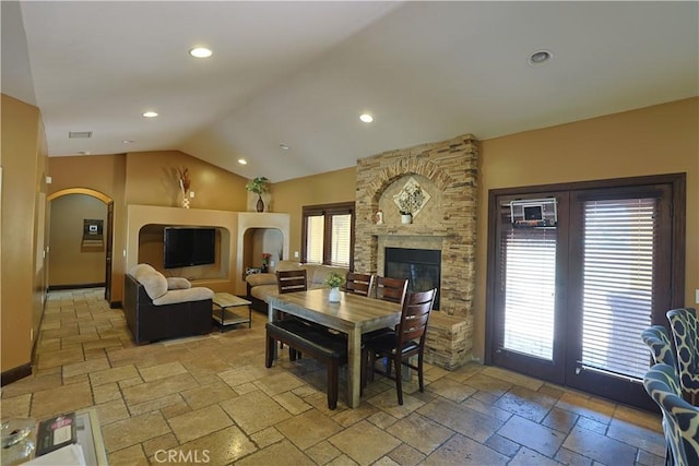 22331 Walnut St, Wildomar, CA 92595 - living room with lofted ceiling, stone tile flooring, arched walkways, recessed lighting, and a fireplace
