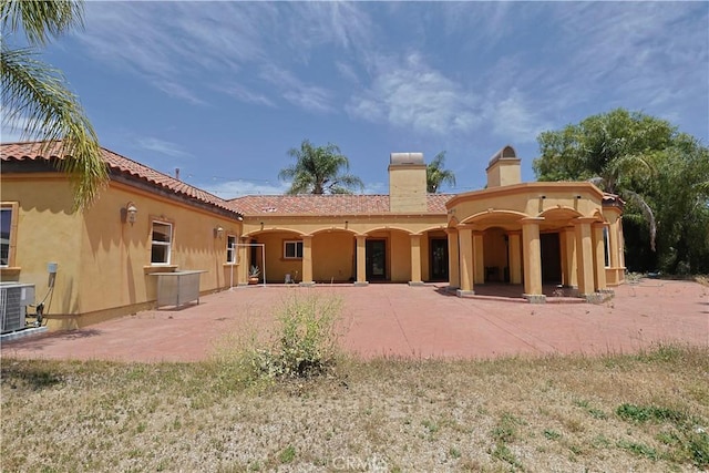 22331 Walnut St, Wildomar, CA 92595 - back of house with stucco siding, central AC, a chimney, and a patio area