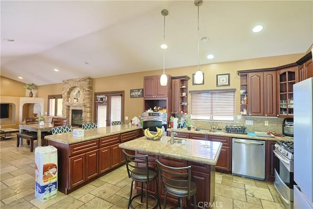 22331 Walnut St, Wildomar, CA 92595 - kitchen featuring stainless steel appliances, stone tile floors, open shelves, vaulted ceiling, and plenty of natural light