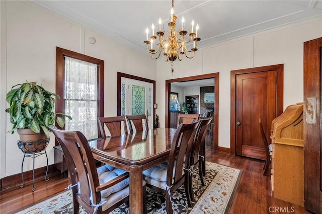 8213 Ocean View Ave, Whittier, CA 90602 - dining room with a chandelier, dark wood finished floors, and ornamental molding