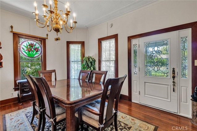 8213 Ocean View Ave, Whittier, CA 90602 - dining space featuring a chandelier, dark wood-style flooring, baseboards, and ornamental molding