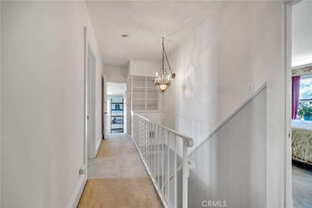 8213 Ocean View Ave, Whittier, CA 90602 - hall with an upstairs landing, a chandelier, light carpet, and baseboards