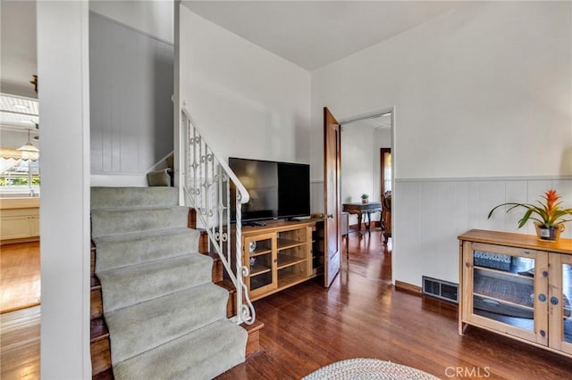 8213 Ocean View Ave, Whittier, CA 90602 - living room featuring stairway, wood finished floors, and a wainscoted wall