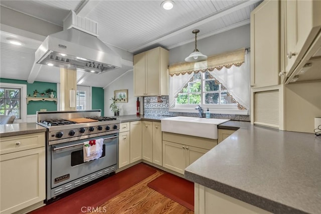 8213 Ocean View Ave, Whittier, CA 90602 - kitchen with premium stove, a sink, wall chimney exhaust hood, cream cabinets, and plenty of natural light