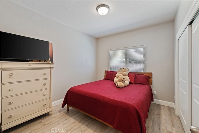 748 Expedition Way W, Madera, CA 93636 - bedroom with light wood finished floors, a closet, and baseboards