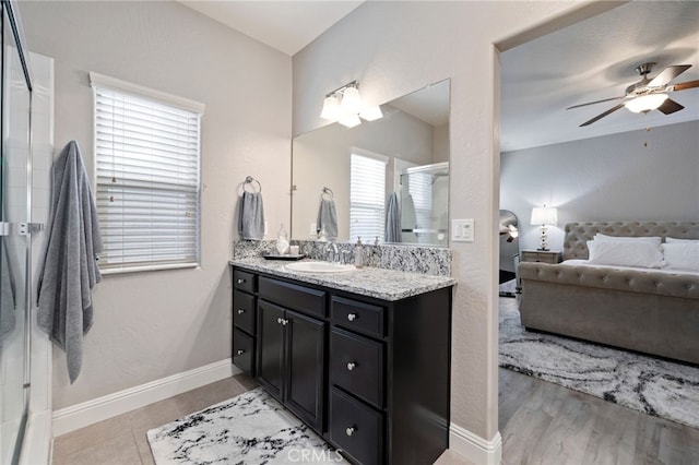 748 Expedition Way W, Madera, CA 93636 - ensuite bathroom with ceiling fan, vanity, a shower stall, and baseboards