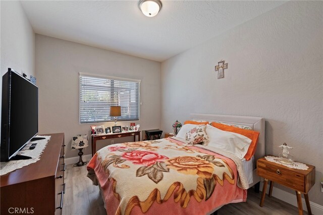 748 Expedition Way W, Madera, CA 93636 - bedroom with wood finished floors and baseboards